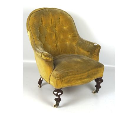 A button back armchair on turned mahogany legs with ceramic castors. 90cm x 70cm x 68cm. 