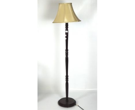 A 20th century electric floor lamp, raised on a turned column and supported on a stepped base, with a cream shade, height (ex