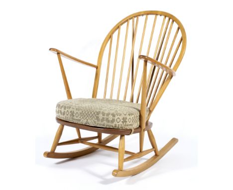 An Ercol style hoop backed rocking chair. with upholstered seat. 105cm(h)