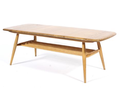 An Ercol style blonde beech and elm coffee table of rounded rectangular form, with spindle rack under tier to the splayed str