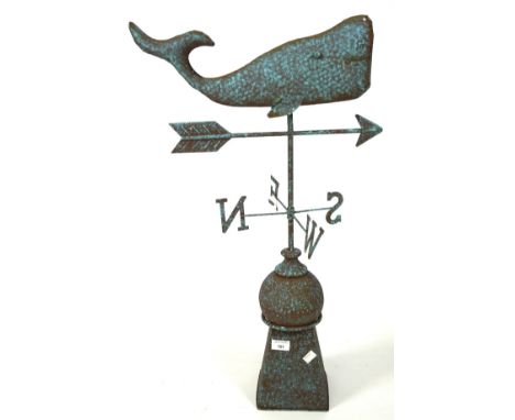 A contemporary painted metal weather vane, adorned with a stylised finial in the form of a whale, approximately 80cm high