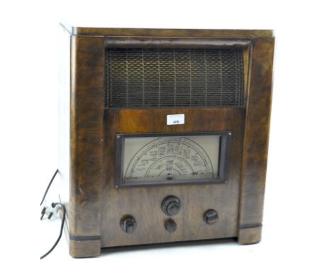 A vintage radio, having a speaker to the front and four dials, in a wooden case, height 50cm