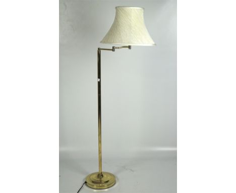 A contemporary standard lamp, raised upon circular base with swivel top, with fabric shade, 141cm high including shade