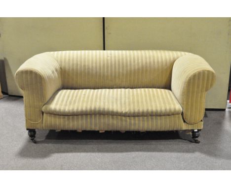 A Victorian two seater green striped sofa on turned supports and casters, height circa 75cm, width circa 170cm