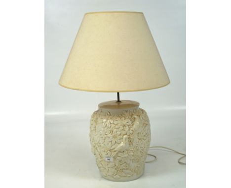 A large contemporary white glazed table lamp, adorned with scenes depicting birds and leaves, with shade, 50cm high excluding