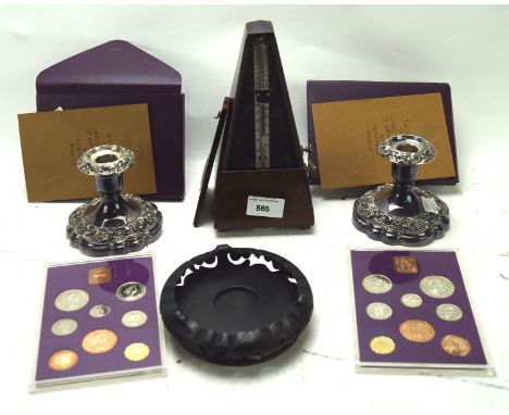 An assortment of collectables, to include a pair of silver plated candlesticks, a Metronome and coin sets