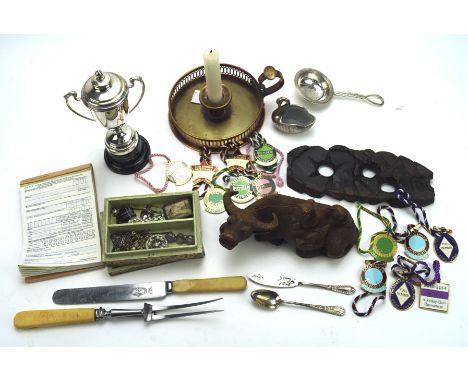 A variety of collectables, including a carved wooden model of a bull, a pierced copper candlestick, an assortment of brooches