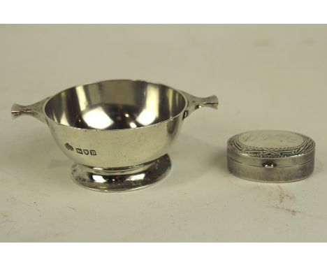 An early 20th century small Silver quaich and a silver pill pot, the quaich hallmarked London 1912 by Elkington &amp; Co, 8cm