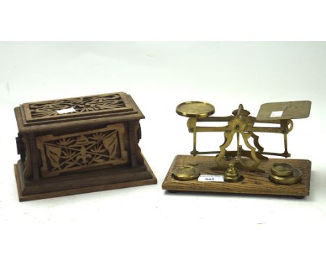 A set of brass scales and a wooden 'Scouts' box, the scales mounted on a wooden base with a selection of weights, the box car