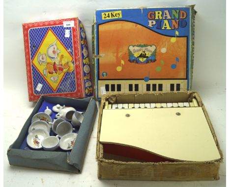 A vintage child's tea service and a child's 24 key grand piano, both in original boxes