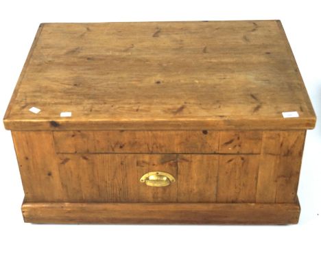 A wooden trunk converted into a coffee table, of rectangular form with a hinged lid and raised on bun feet, 39.5cm x 81cm x 5