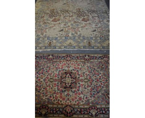 An Isfahan style ivory ground carpet woven with birds among flowering trees, 280 x 210 cm; together with a similar rug.