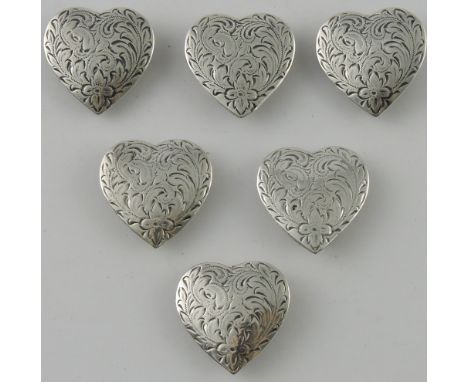 A set of six interesting late Victorian white metal decorative button covers, of heart-shape and decorated with foliage, 1.1o