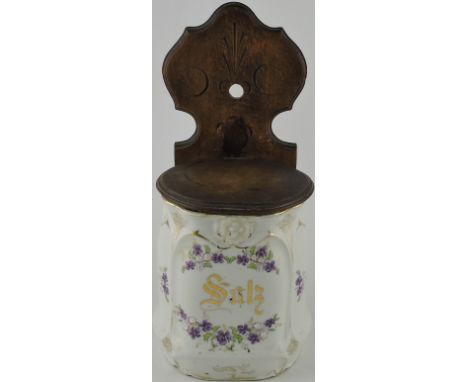 A late 19th century German ceramic salt with wooden hanging mounts and cover, H. 31cm.