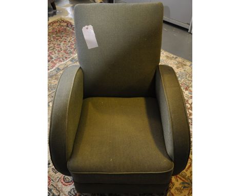 An Art Deco armchair, covered in a loose green fabric.