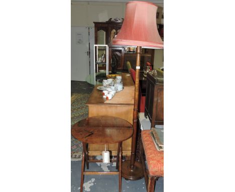 An early 20th Century oak folding coaching table together with a beech standard lamp and shade. 