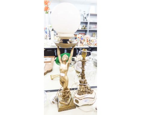 A MARBLE AND BRASS TABLE LAMP, STYLIZED BRASS STAND WITH TWO CHERUBS PERCHED ON A SHAPED MARBLE BASE, ALL RAISED ON BRASS TRI