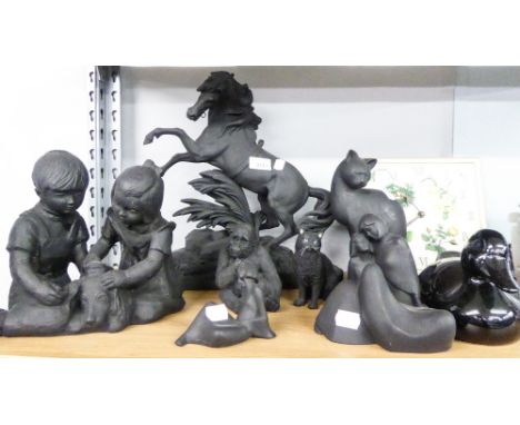 A BLACK PAINTED SPELTER REARING HORSE ORNAMENT, SEVEN MODERN BLACK COMMEMORATIVE FIGURES, ANIMAL ORNAMENTS AND A SQUARE WALL 