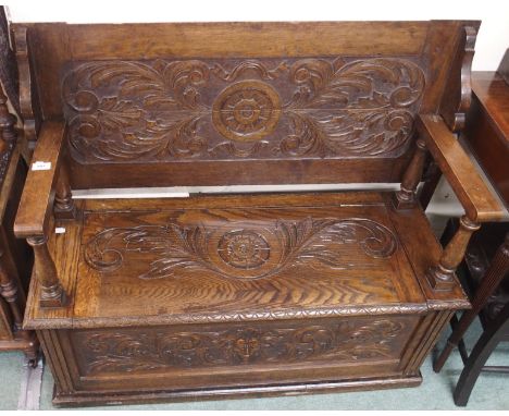 An oak monks bench with carved panels Condition Report: Monks bench has a split to the top/back and shows signs of possibly b