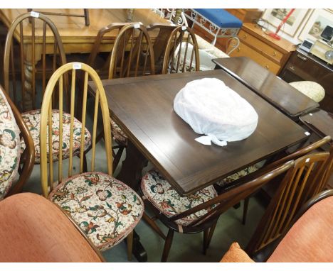 An Ercol dining table with five dining chairs and a light Ercol dining chair (7) Condition Report: Available upon request