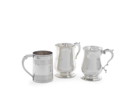 Three George III silver mugsfirst two, of baluster form with leaf-capped scroll handle, maker's mark W.B, London 1785, front 