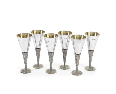 STUART DEVLIN: a set of six silver and silver-gilt gobletsLondon 1968 The tapering polished bowls with a light spot hammered 