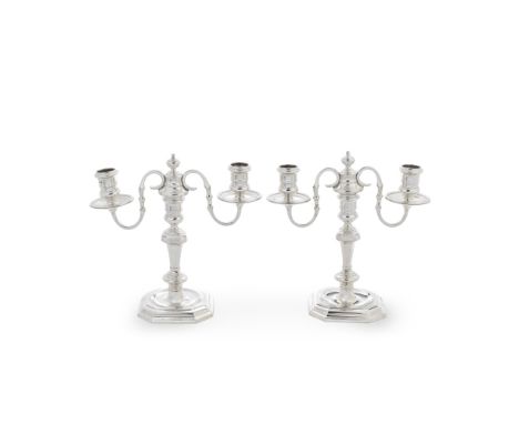 A pair of cast silver two-light candelabra, in the 18th century stylemaker's mark J C L in a shaped device, London 1962 With 