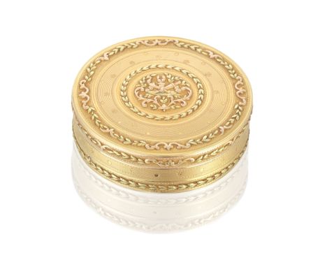 A Louis XVI circular vari-coloured gold snuff boxAntoine Louis Anthiaume, Paris 1786 The cover with a central chased panel wi