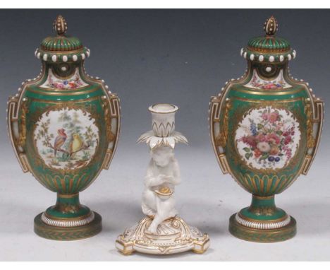 A pair of Sevres style porcelain vases and covers, the green ground bodies reserved with panels of birds and flowers, 31cm hi