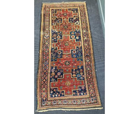 A red and blue Karabagh with five lozenges to the central panel 284 x 127cm