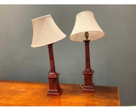 A pair of painted faux porphyry column table lamps 67cm high including fittings (2)The lamps are closer to a red colour than 