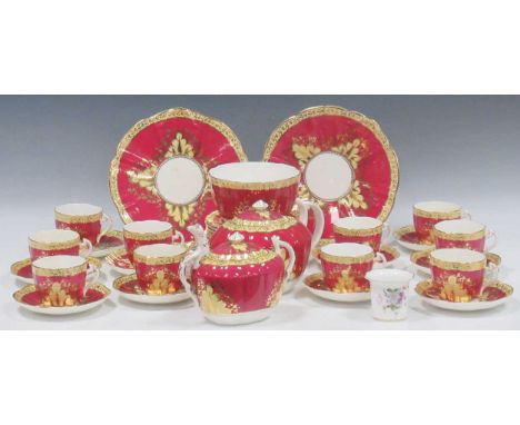 A collection of various bone china tea and coffee services, including a fuschia and gilt service, comprising two teapots, mil
