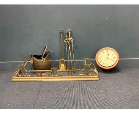A brass fender, fire tools and bucket; with a fusee wall clock