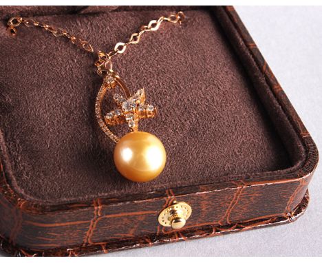 A modern 18ct rose gold and diamond pendant, star shaped with large pearl like stone, on an 18ct gold chain, marked 750, in a