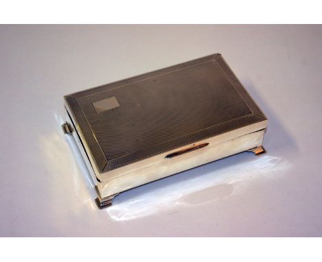 A silver mounted cigarette box, engine turned, on bracket feet Bert Gordon, Birmingham, 1963 10.4 troy oz in total