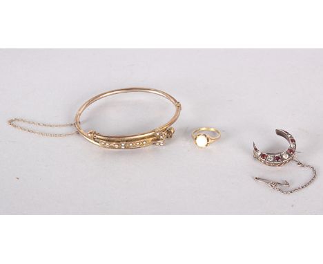 A gold coloured bangle inset with seed pearls, a ring and a crescent shaped brooch (3) 