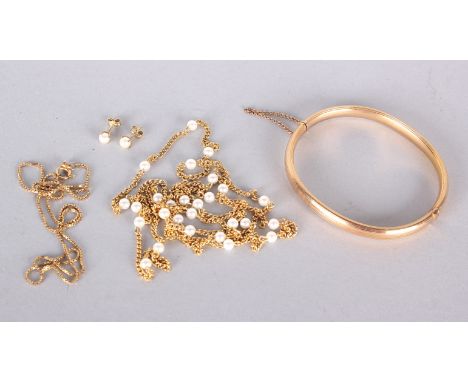 A 9ct gold hollow bangle, marked 9ct, 8.6g,  a 9ct gold chain necklace, 2.6g and a gold coloured necklace with matching earri