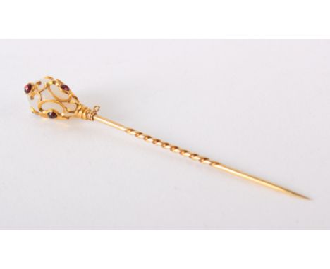 A late 19th/early 20th Century gold, moonstone () and ruby hat/stick pin, marks rubbed, boxed 