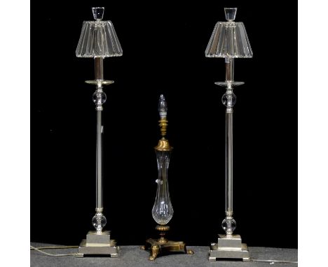 Pair of modern glass and chrome table lamps, faceted shades, stepped silvered bases, 85cm; and another modern gilt metal and 