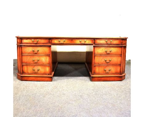 Mahogany effect twin-pedestal partners desk, green leather inset top, cantered corners, each length with three frieze drawers
