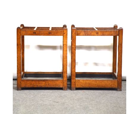 Pair of Edwardian oak stick and umbrella stands, square section, each with six divisions, black metal removable tray, width 4