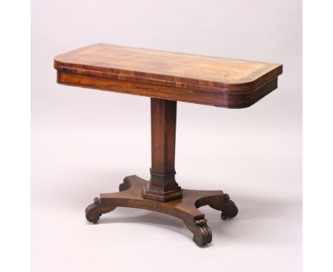 A REGENCY ROSEWOOD AND BRASS INLAID FOLD-OVER CARD TABLE, baize lined, hexagonal column support, on a platform base with carv