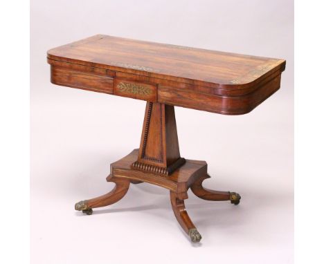 A REGENCY ROSEWOOD AND BRASS INLAID FOLD-OVER CARD TABLE, with baize lined surface, tapering square column support, platform 