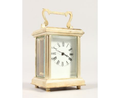 A MINIATURE CARRIAGE CLOCK, with silver plated case and white enamel dial. 8cms high.