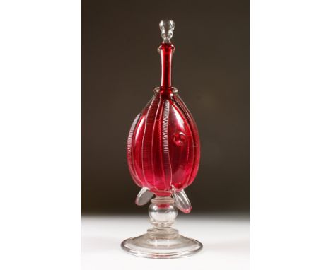 A VICTORIAN RUBY GLASS BELLOWS SHAPED DECANTER AND STOPPER. 36cms high.