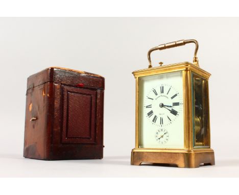 A FRENCH BRASS CARRIAGE CLOCK, with repeat and alarm, striking on a gong, in a leather case. 14cms high.