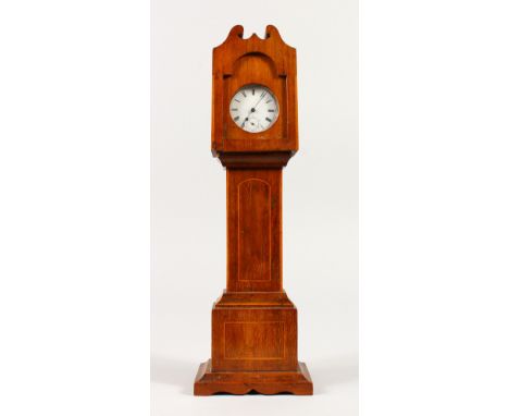 A MINIATURE MAHOGANY LONGCASE CLOCK with watch movement. 32cms high.