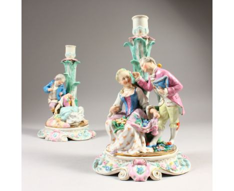 A PAIR OF AUGUSTUS REX PORCELAIN CANDLESTICK GROUPS, gallant and lady on an oval base. Mark in blue.  24cms high.  Lady figur