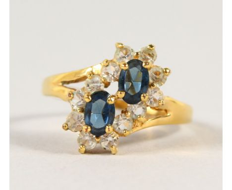 AN 18CT GOLD AND SAPPHIRE CROSSOVER RING.