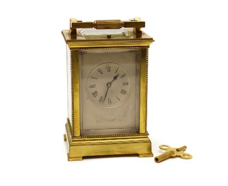 A brass cased carriage clock, c.1900, the silvered dial with Roman numerals, the two train movement striking on a gong with a